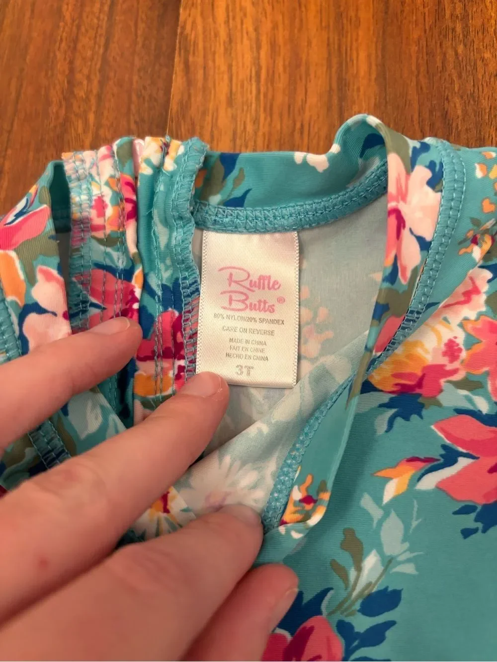 RuffleButts blue floral long sleeve rashguard one piece bathing suit